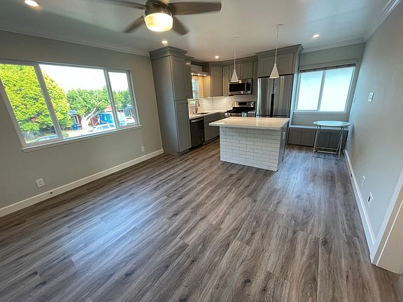 Open concept kitchen and living room with Island seating and a bench seat!