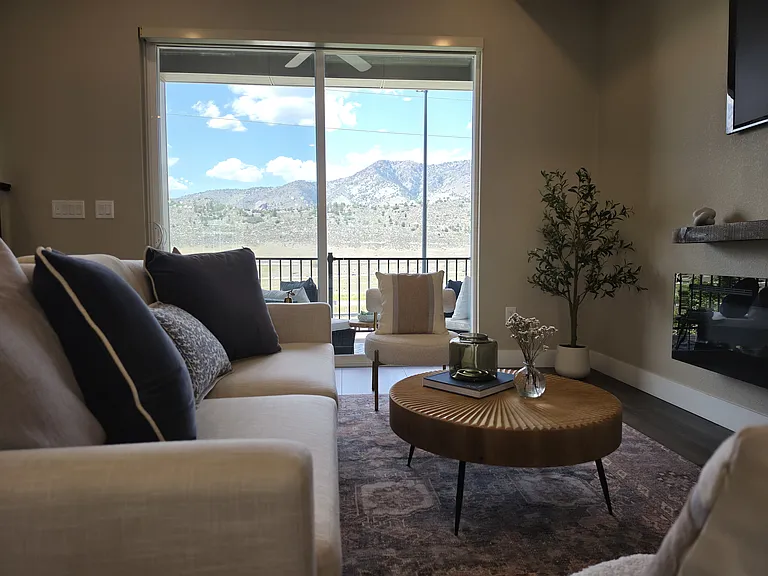 Living room blends seamlessly into patio with mountain views