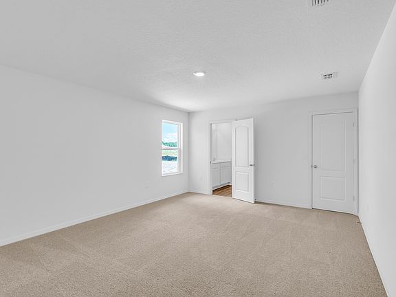 The spacious master bedroom is the perfect place to relax after a long day