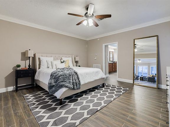 Primary bedroom with en-suite is on the first floor and has an adjoining sitting room.