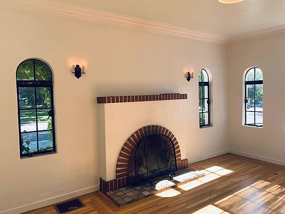 wood burning fireplace with screens and tools