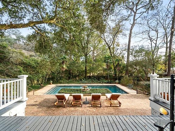 View of swimming pool with a wooden deck and a patio area