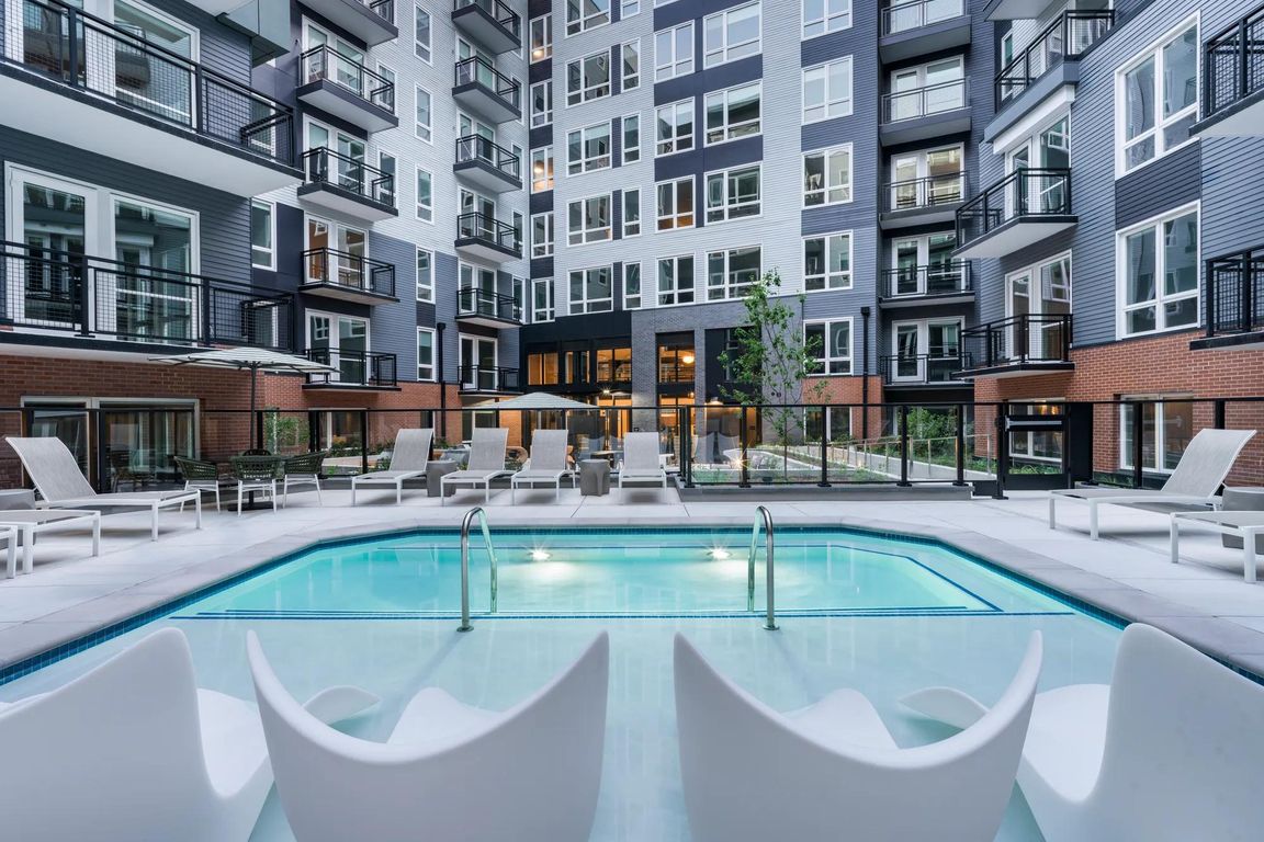 Soak, sun, and unwind in our resort-style courtyard pool, complete with in-water loungers, private seating, and a peaceful city backdrop.