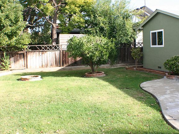 large yard w/irrigation and mature fruit trees.