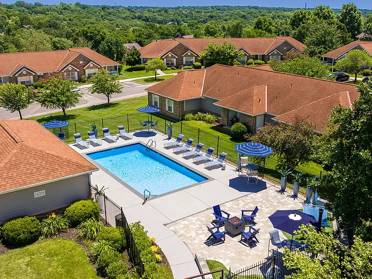 Experience our serene pool area complete with comfortable lounge chairs, shaded seating, and a cozy fire pit for perfect relaxation and socializing.