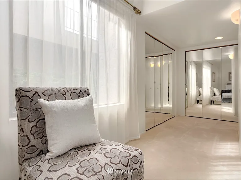 Primary bedroom leading to double closets and en suite