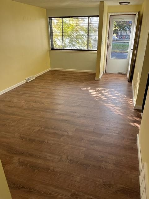Living room with a brand new storm door with screen.