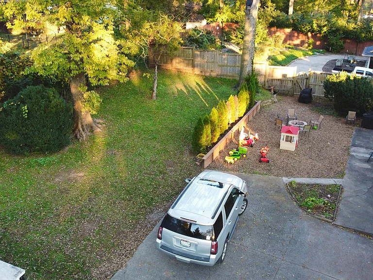 Backyard with fire pit; the storage container in the lower left corner will be removed; Big Green Egg May stay with the property