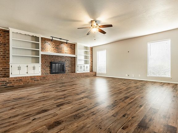 Large living room with gas fireplace and built-in bookcase. Great space for any family!