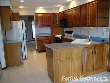 Kitchen
						:
						View of custom-made cabinetry that includes a pantry and appliance garage.