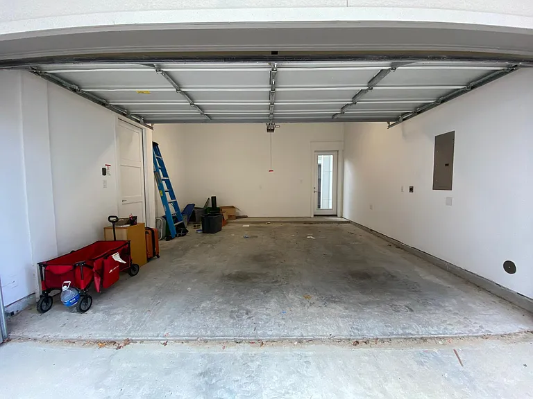 2 car garage with electric vehicle charging (NEMA 14-30 plug). Garage accommodates 1/2 ton pickup (Ram 1500, F150, Silverado 1500)