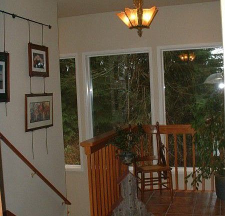 The front door opens to a cozy reception area, with Mediterranian-style ceramic tile and a comfortab