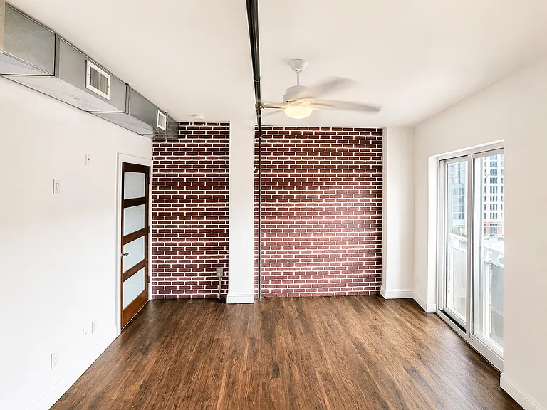 Large primary suite with high ceilings and abundant natural light.
