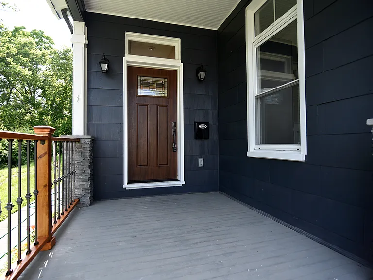 Lovely front porch with stone half columns.