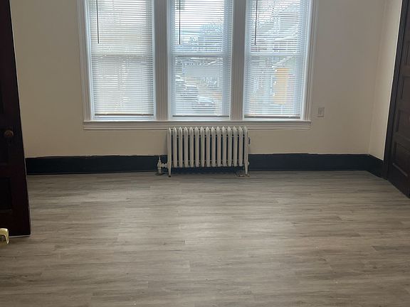 Front Room with new windows, paint, floors and large closets for storage.