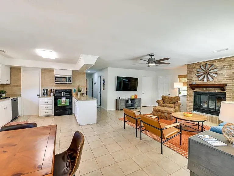Dining, fully stocked kitchen, living room. Hallway to bedrooms and hall bath.