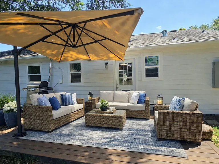 Digital staged photo. Welcome to a friendly outdoor living space that feels inviting to the outdoor backyard.