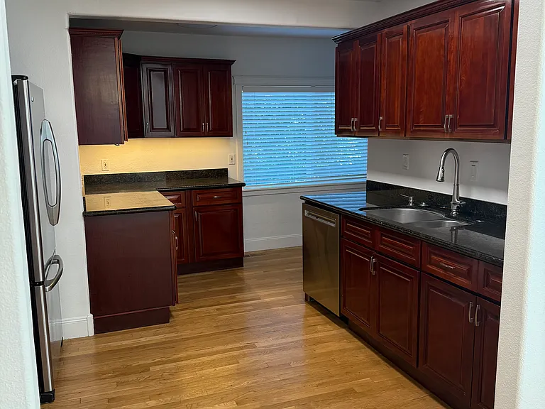 Kitchen view from dining, freshly painted cabinets and lots of storage space. New Dishwasher