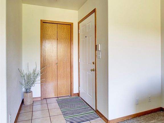 The entryway has tile floors and a big closet for storage.