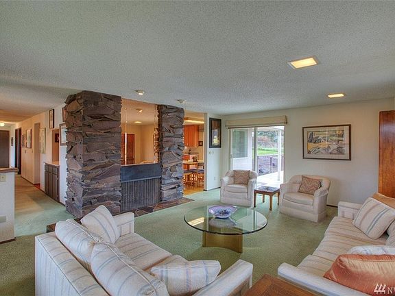 Living room with dramatic wood burning fireplace made with Columbia Basin Basalt. 