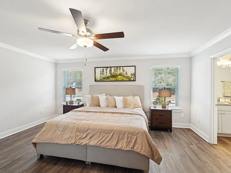 Primary Bedroom with king size bed and large window letting in nice natural light.