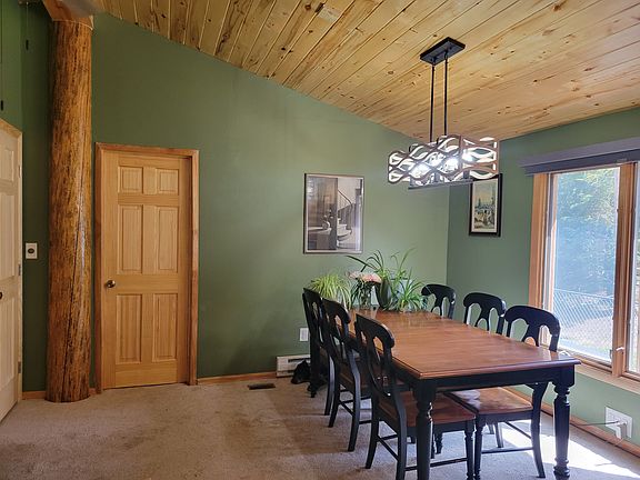 Upstairs dining room with natural light and room for large dining table. Doors down to downstairs and primary bedroom suite. Dog not included.