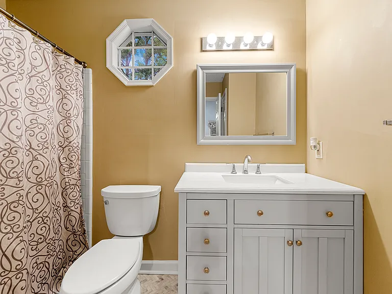 Bathroom upstairs, bathtub and a new showerhead. New vanity installed in 2021.