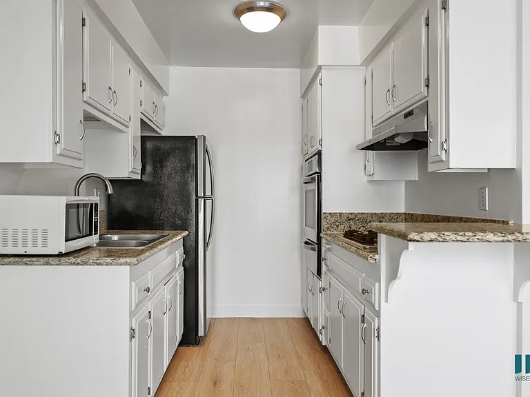 Kitchen with Stainless-Steel Refrigerator, Stovetop, and Oven