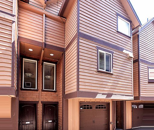 Entrance to 118 B, with 1-car attached garage.