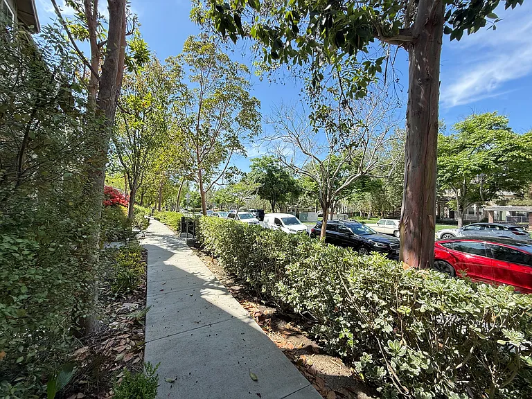 Peaceful view from your private entrance with mature trees and lush landscaping.