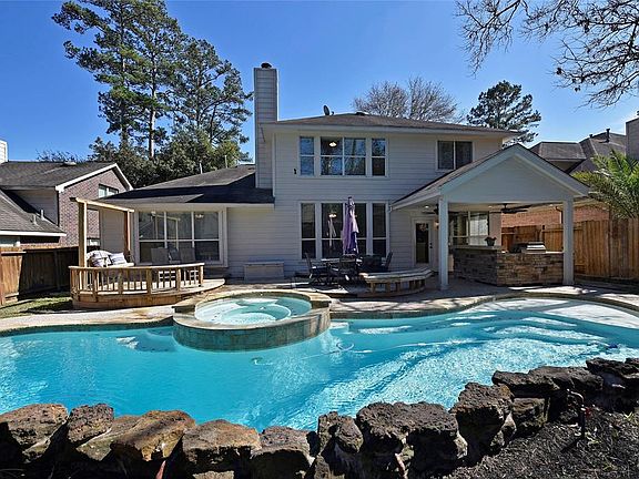 Big Saltwater pool and spa with rock waterfalls. Large heated spa, covered summer kitchen and custom made curved deck.