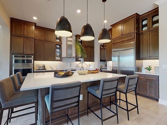 The butler s pantry and walk-in pantry provide even more space to this well-equipped kitchen, which