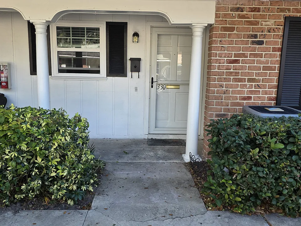 Front door and sitting area in front of the unit. The window looks into the Kitchen.