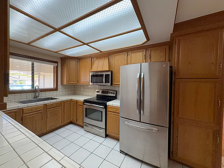 Full-height pantry cabinet and stainless steel appliances included