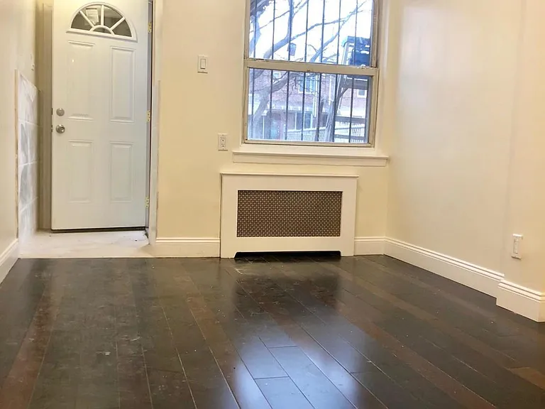 Dining area/living room after front door and front window. Taken from kitchen bar area.