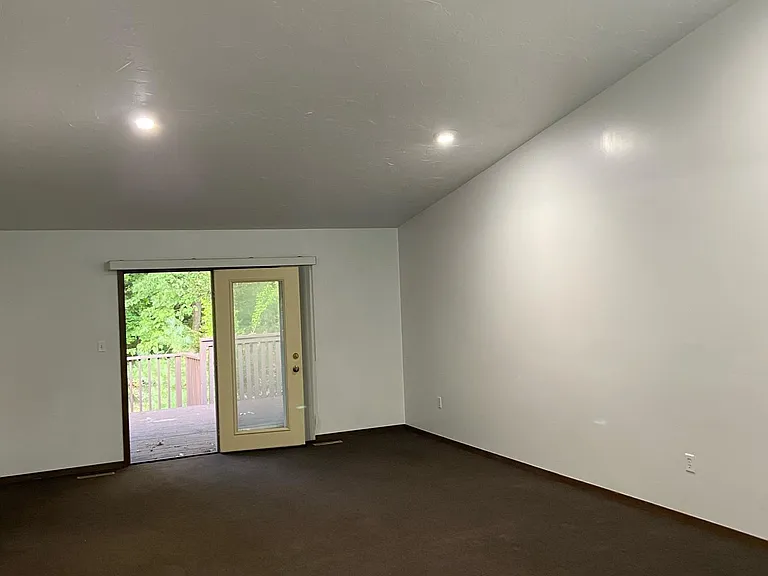 living room with a door to the backyard onto a deck