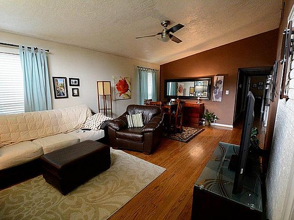 Spacious living/dining combo with bright windows, updated lighting,