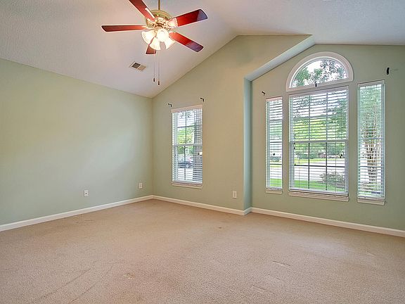 Primary bedroom with high ceilings