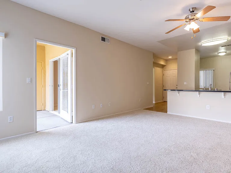 Carpeted Living Room with Balcony