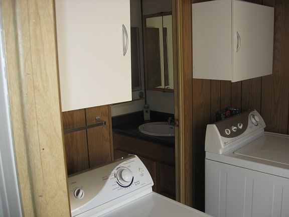 Hallway glimpse of  bathroom