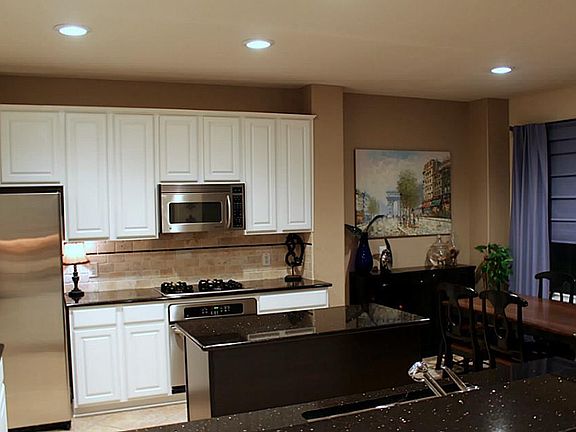 OPEN CONCEPT, EAT-IN KITCHEN OFFERS TONS OF CABINETRY, GRANITE COUNTERTOPS AND STAINLESS APPLIANCES