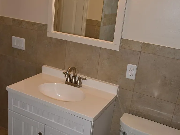 Bath: 3 compartment vanity, 4 light decorator fixture, upgraded toilet, oversized mirror, porcelain tile, Moen faucets, exhaust fan, linen closet