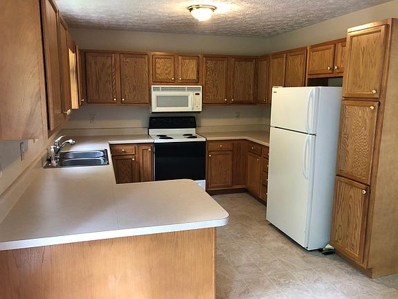 Open plan kitchen with plenty of cabinets; dishwasher, range