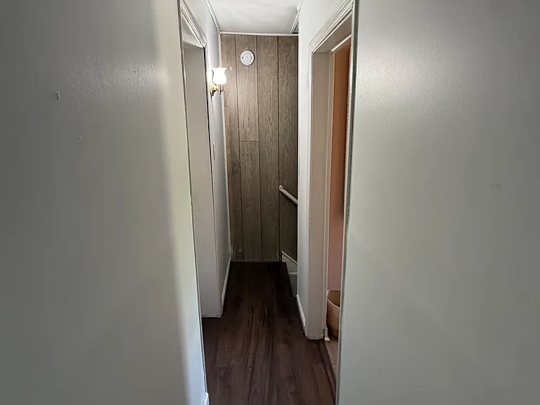Hallway leading back to staircase to kitchen