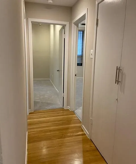 Hall to bedrooms with a walk-in closet