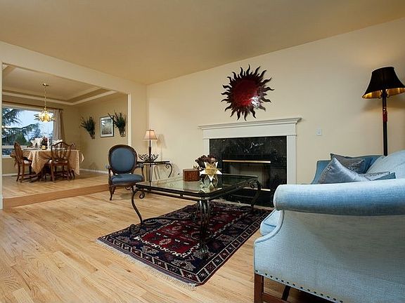 Living room off main entry with wood burning fireplace.