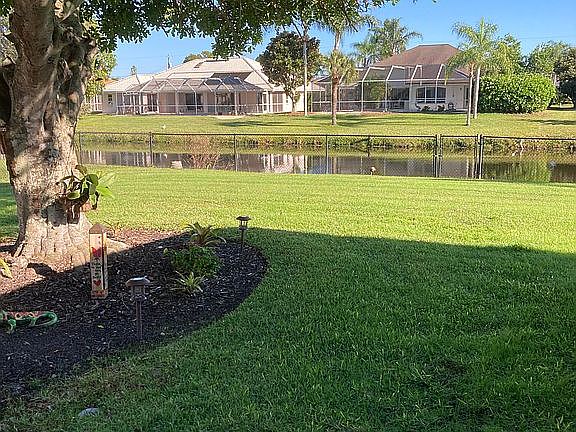 Large fenced yard canal view