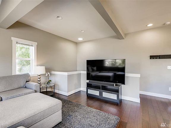 Beautiful bamboo floors grace the captivating great room. Ahead are the stairs to the lower level.