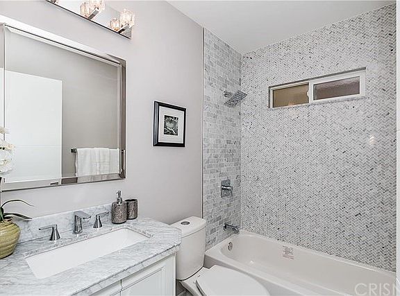 Beautiful bathroom with Cararra Marble vanity, sho