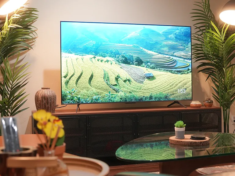 Living Room comes with a 65" TV along with leather sofa and an Herman Miller inspired glass coffee table